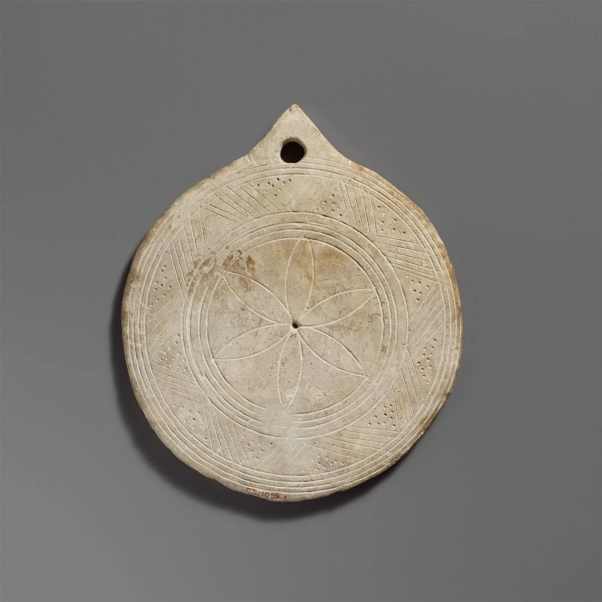 Limestone disk with geometric decoration — Unknown