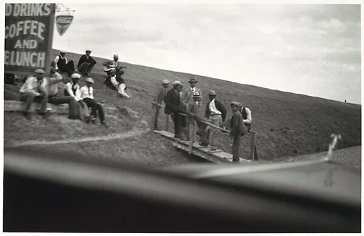 [Guitar Player and Group of Men on Levee, Seen from Car Window, Vicinity New Orleans]