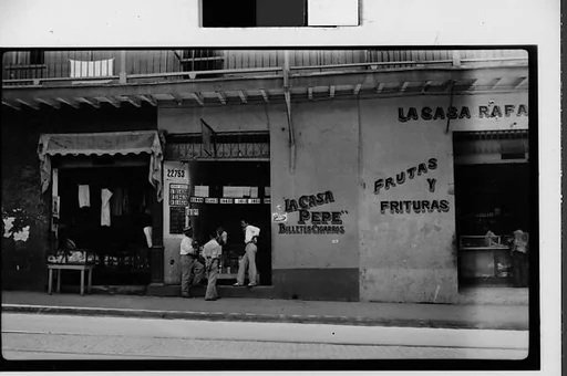 [Street Scene in Front of Lottery Ticket Shop "La Casa Pepe" and Fruit Market "La Casa Rafael", Havana]