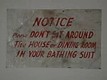 [Hand-painted Sign: "Notice: Please Don't Sit Around The House or Dining Room In Your Bathing Suit"]