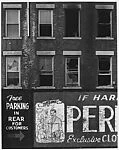 [Façade of Brick Building with Men's Clothing Advertisement]