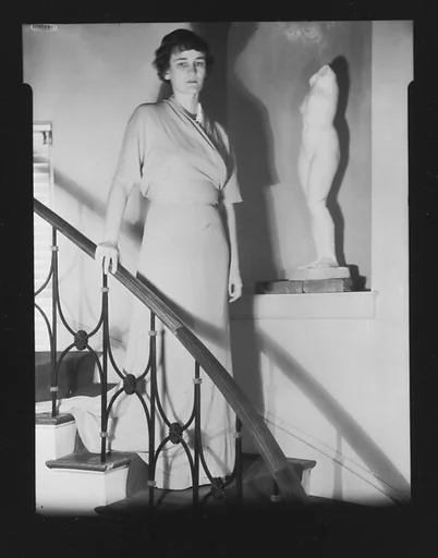 [Jane Fuller on Stairwell Next to Statue in Niche, Bedford, New York]
