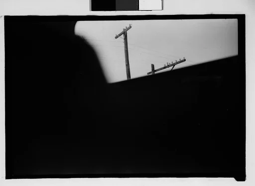 [Seven 35mm Film Frames on Uncut Roll: 5 Views of Wagons and Buildings at Ringling Brothers Circus Winter Quarters, Sarasota, Florida, 1 Study of Illustrated Bank Calendar for November 1941, and 1 Test Frame Inside Automobile]