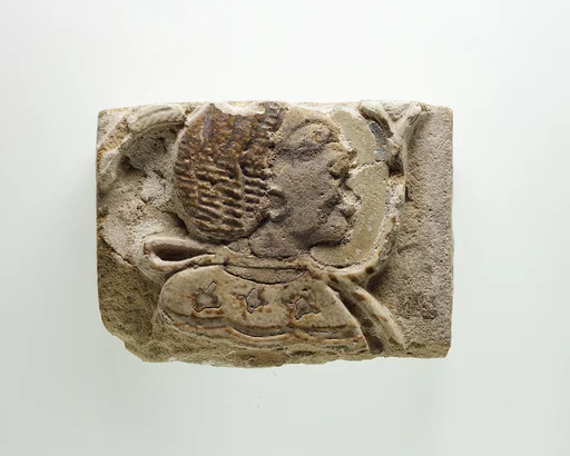 Tile fragment with a head of a prisoner