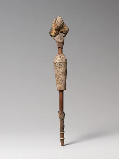 Female figurine on a reed