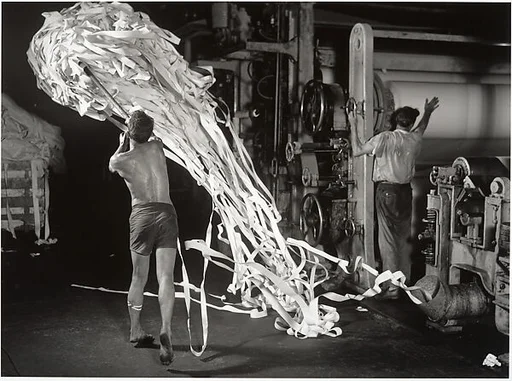 [Paper Mill Worker Removing Waste from Machine]