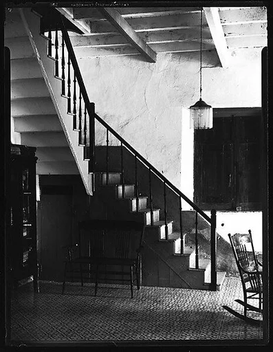 [Entryway Interior with Stairwell, Rocking Chair, and Bookcase, Possibly Havana]