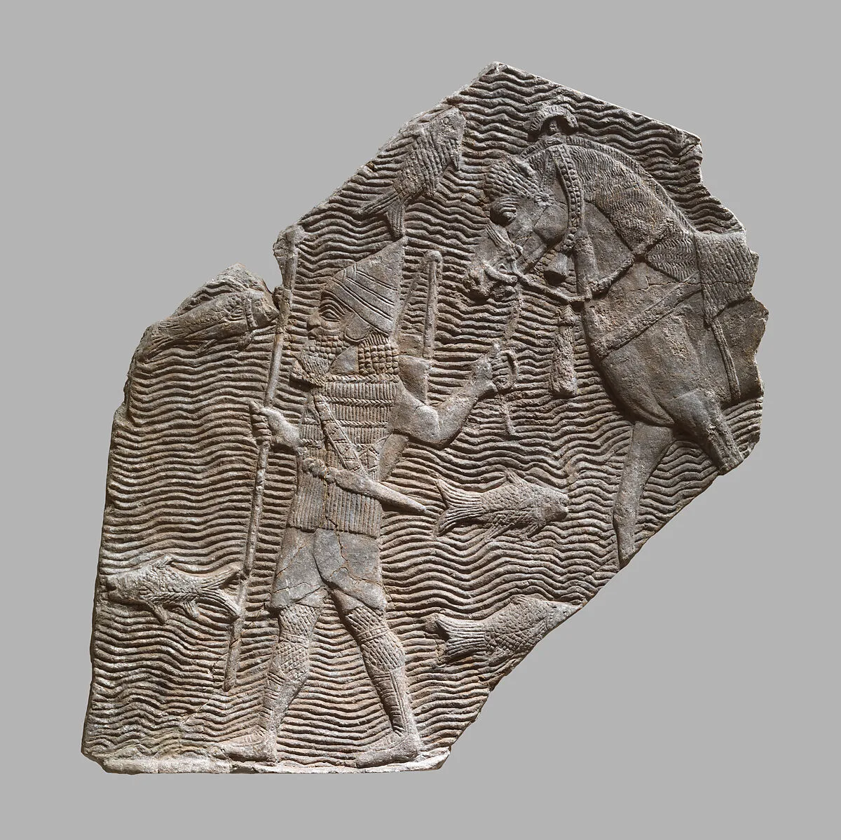 Relief fragment: cavalryman leading his horse beside a stream — Unknown