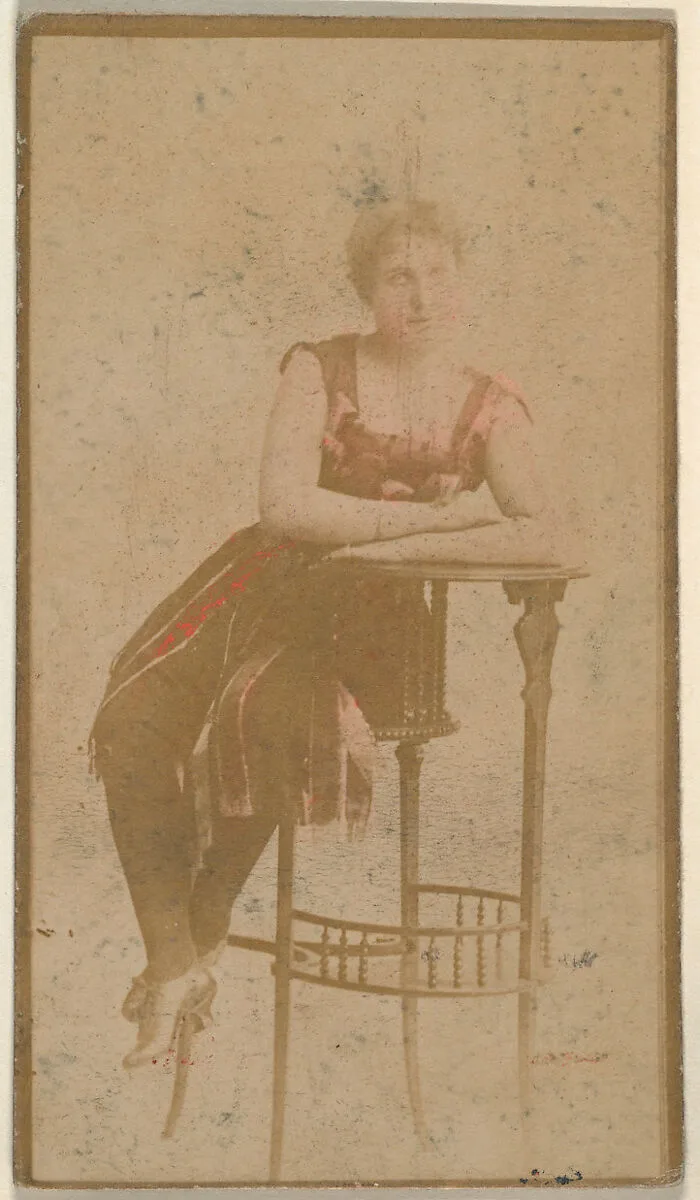 Seated actress leaning on table, from the Actresses series (N668) — Unknown