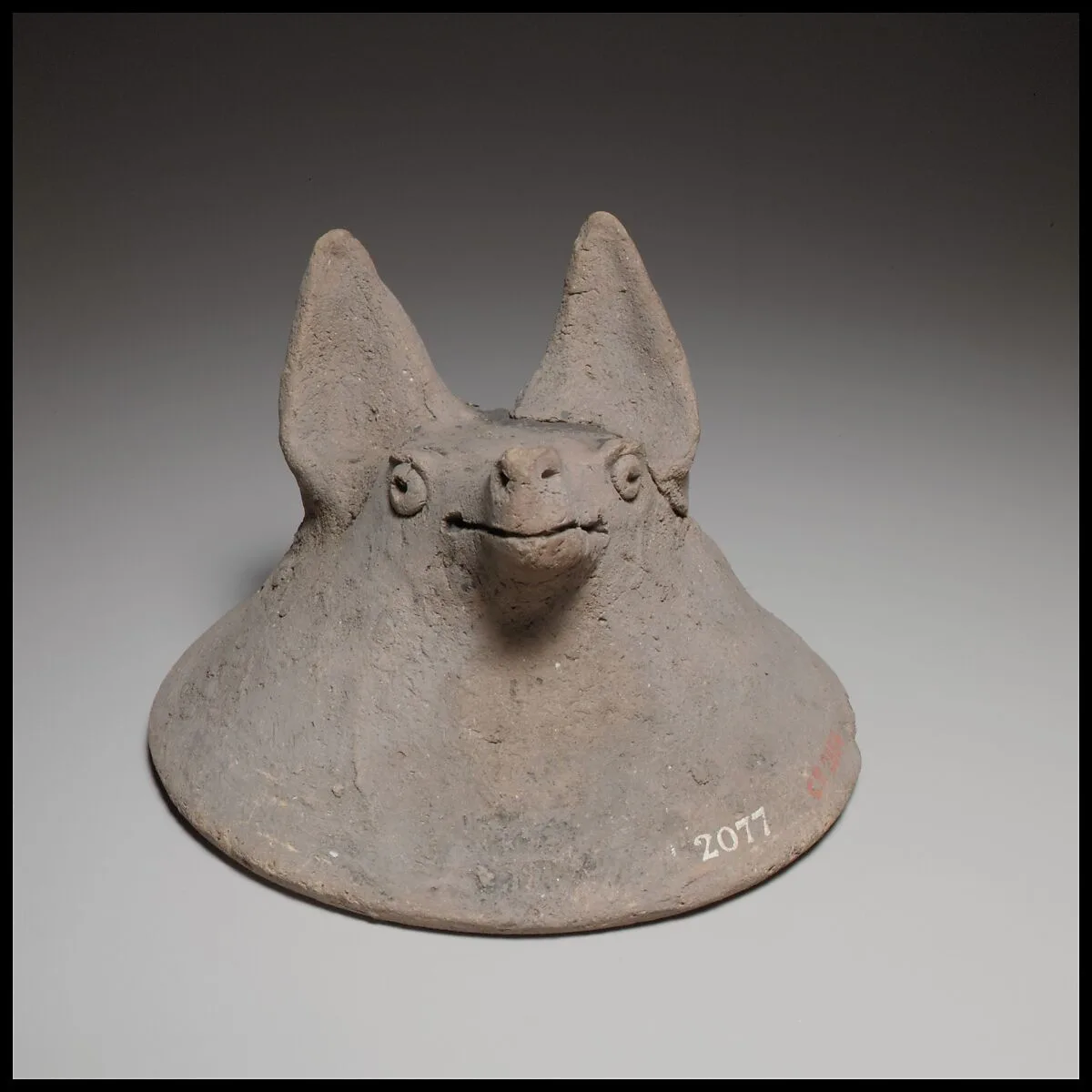 Terracotta mask in the shape of the head of a fox, dog, or bat — Unknown