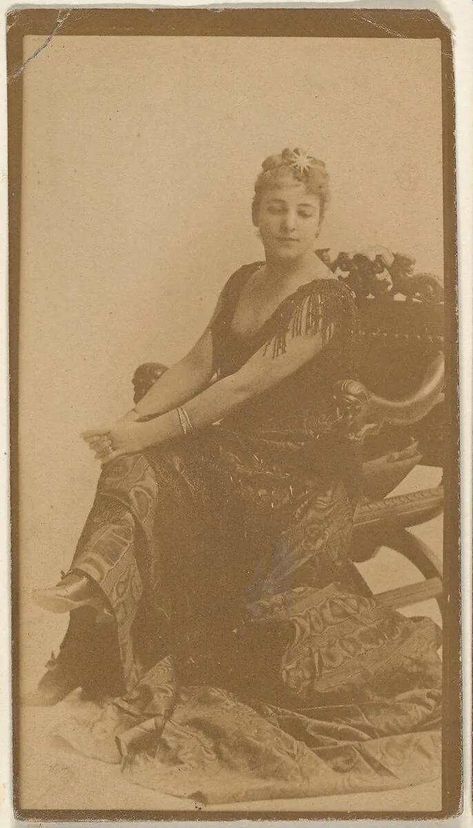 Seated actress with hands resting on knees, from the Actresses series (N668) — Unknown