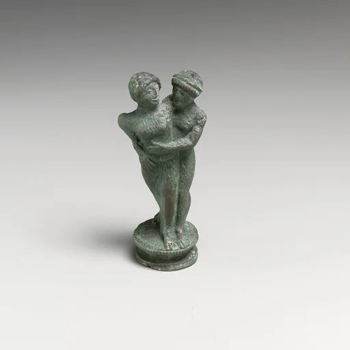 Bronze candelabrum finial showing a man embracing a woman