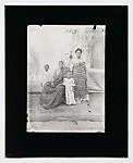 Family with two children, parents in Ewe kente cloth with painted backdrop