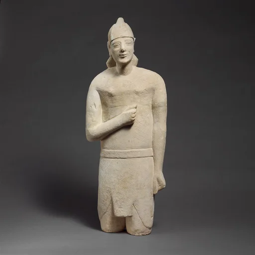 Limestone statuette of a beardless male votary in Egyptianizing dress wearing a helmet