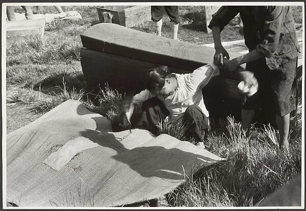 A woman mourns her husband, killed in the battle of Taierhchwang, April — Robert Capa