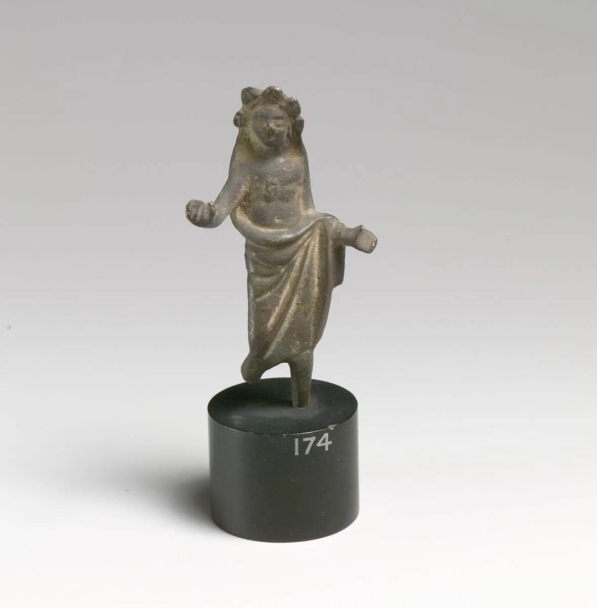 Statuette of a man wearing a mantle over head — Unknown
