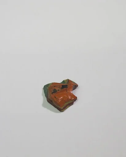 Mold-pressed amulet or fragment