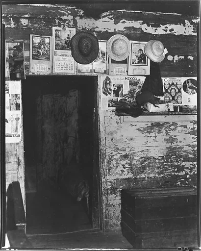 [Advertisements and Straw Hats on Wall around Entrance to Frank Tengle's Bedroom, Hale County, Alabama]