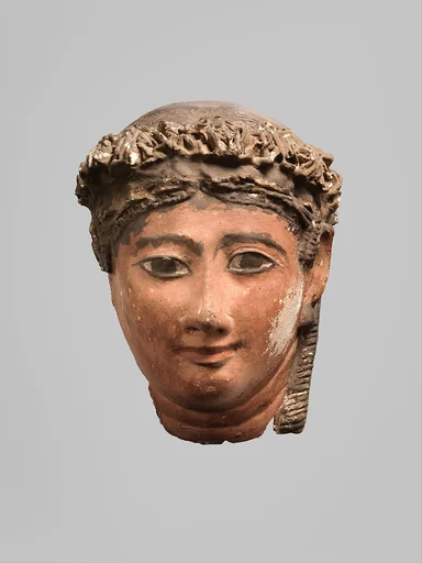 Mask of a woman with corkscrew locks and ball earrings