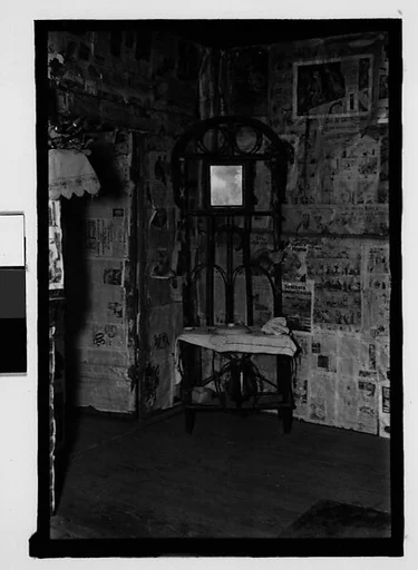 [Interior with Newspaper-Covered Walls and Wire Mirror Stand, Hale County?, Alabama]