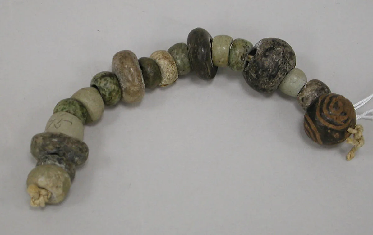 String of flattened beads — Unknown