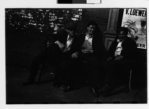 [Three 35mm Film Frames: Three Men Seated in Chairs on Sidewalk, New York City]