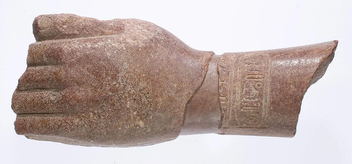 left hand and arm fragment with Aten cartouches from a statue supporting a stela? — Unknown