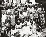 Chief in top hat surrounded by women and children — Alex Agbaglo Acolatse