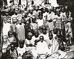 Chief in top hat surrounded by women and children