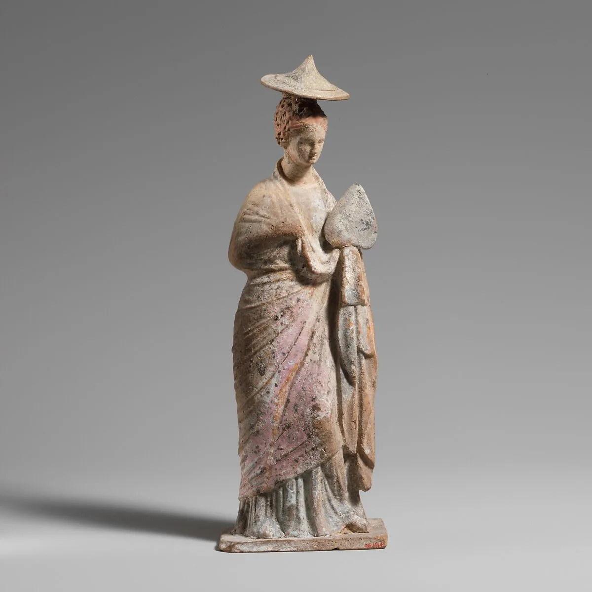 Terracotta statuette of a draped, standing woman — Unknown