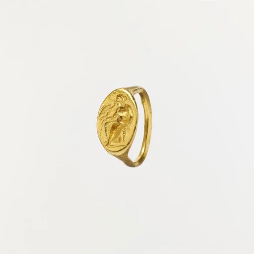 Gold ring with intaglio of seated woman and flying Eros