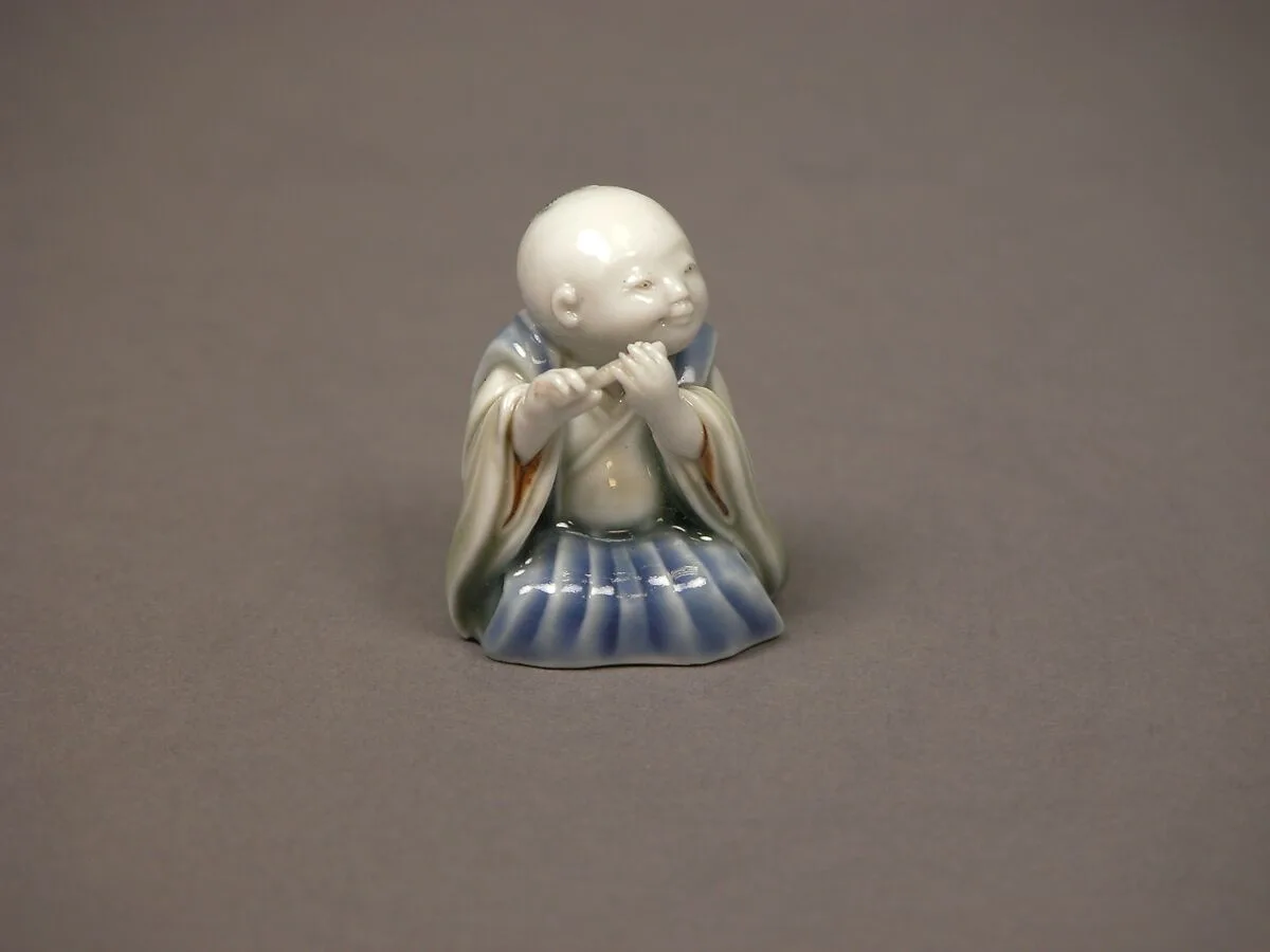 染付色絵囃子唐子形置物|Chinese child with musical instrument — Unknown