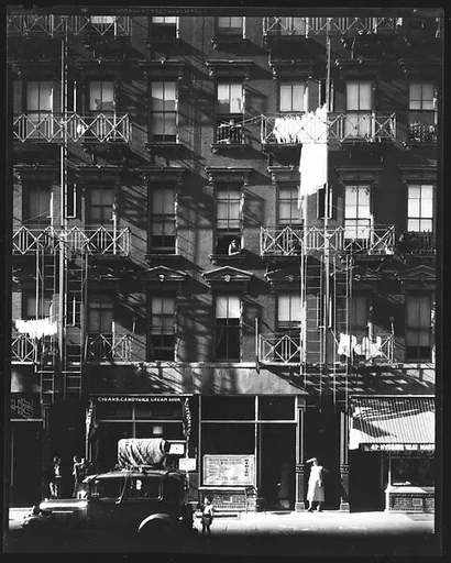 [Tenement Building with Ground Floor Shops and Parked Car on Carmine Street, New York City]