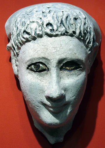 Mask of a man with loose hair combed forward and a mantle