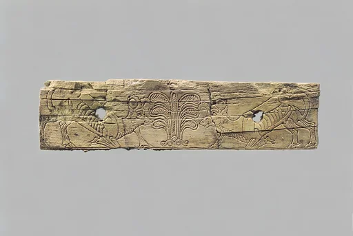 Incised furniture plaque with two ibexes flanking a stylized palmette tree
