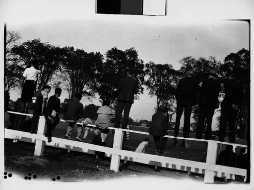 [Spectators Standing and Sitting on Wooden Fence, From Behind, Darien, Connecticut]