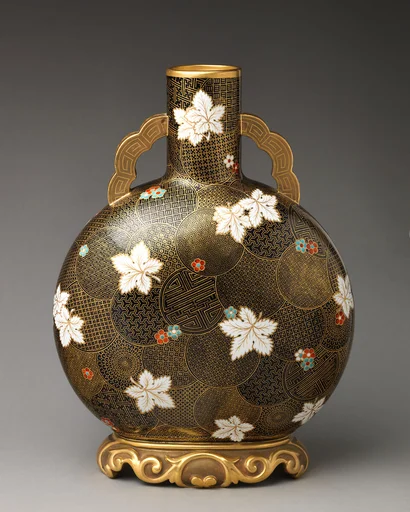 Moon flask with white flower motif on raised foot with flat handles