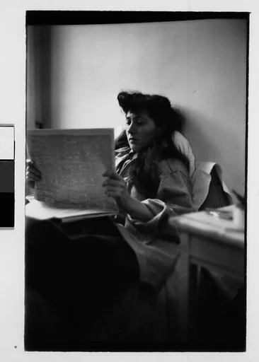 [Five 35mm Film Frames: Jane Smith Evans Reading Newspaper in Bed, New York City]