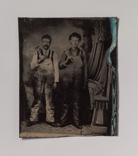 [Two Plumbers in Overalls]