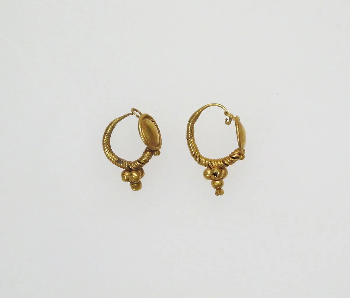 Earring with disk and pendant globules — Unknown