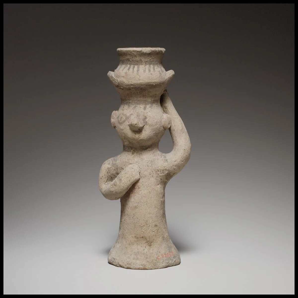 Standing female figurine holding an amphora on her head — Unknown