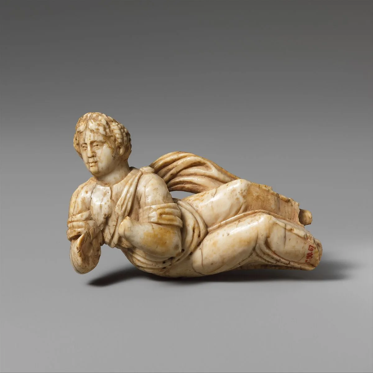 Ivory statuette of a reclining woman — Unknown