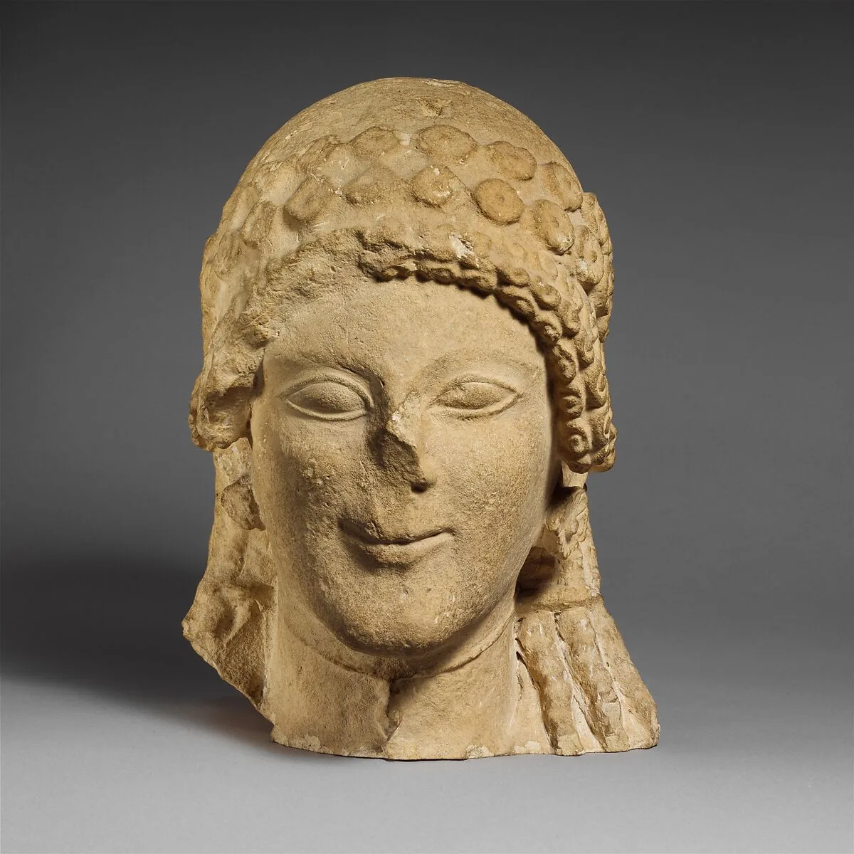 Limestone head of a female votary — Unknown