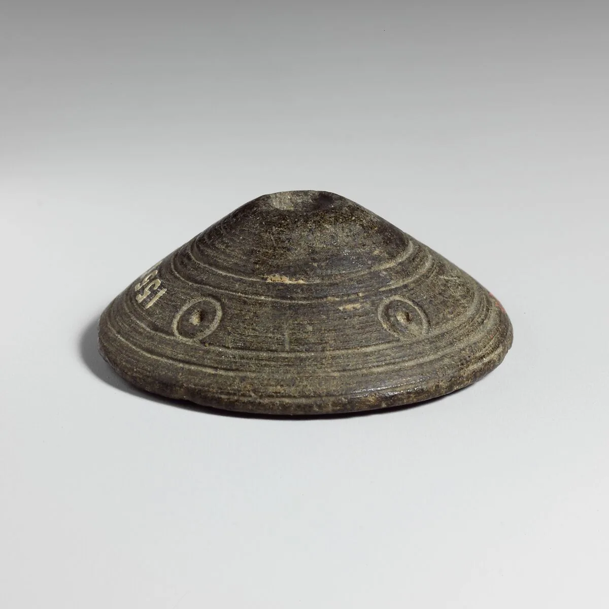 Micaceous schist spindle whorl — Unknown