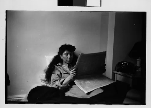 [Five 35mm Film Frames: Jane Smith Evans Reading Newspaper in Bed, New York City]