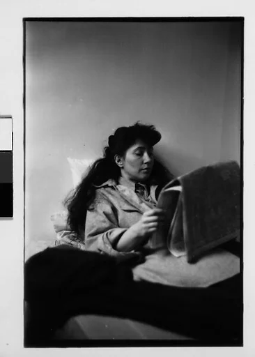 [Five 35mm Film Frames: Jane Smith Evans Reading Newspaper in Bed, New York City]