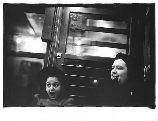 [One 35mm Film Frame: Subway Passengers, New York City: Older Woman and Yawning Little Girl on Times Square Shuttle]