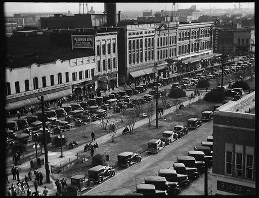 [Stores and Parked Cars on Main Street, From High Elevation, Macon, Georgia]