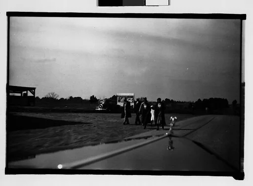 [People Walking by Side of Road, From Moving Automobile, Macon, Georgia]