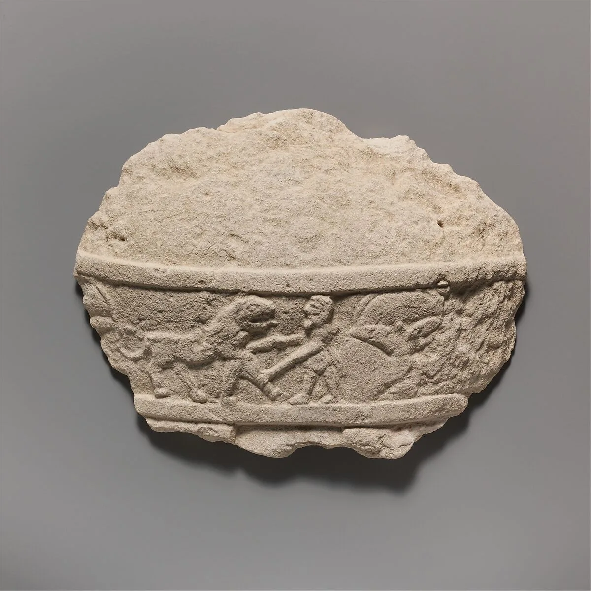 Fragment of a limestone statue of a male votary (worshipper) — Unknown